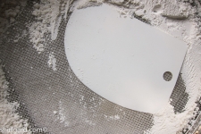 Push Flour Through a Tamis Using a Bowl Scraper