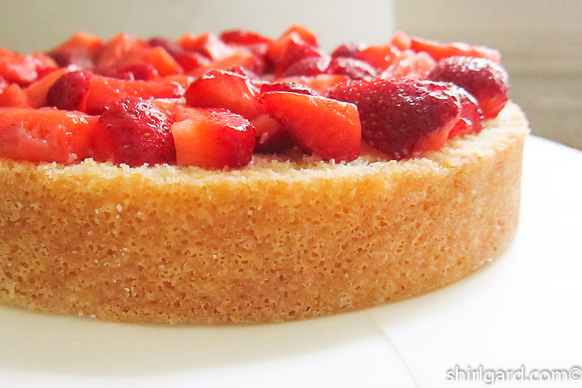 Bottom layer of cake with quartered strawberries